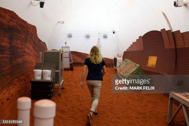 Dr. Suzanne Bell, Lead for NASA's Behavioral Health and Performance Laboratory, walks through a simulated Mars exterior portion of the CHAPEA's Mars...