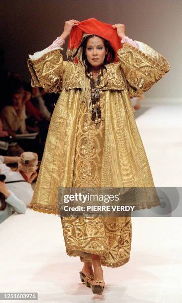 Model shows off a traditional north African golden dress 19 October during the African Mosaic charity fashion show in Paris organized by the...