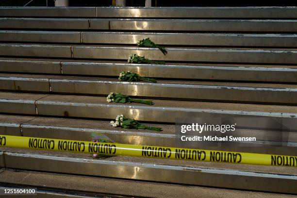 Bouquets of flowers lay at the entrance of the Old National Bank for the victims of the mass shooting on April 11, 2023 in Louisville, Kentucky. On...
