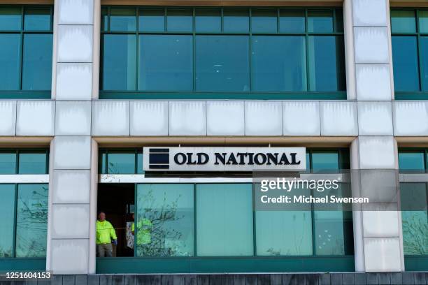 Workers replace a window with bullet holes after a mass shooting at the Old National Bank on April 11, 2023 at Metro Hall in Louisville, Kentucky. On...