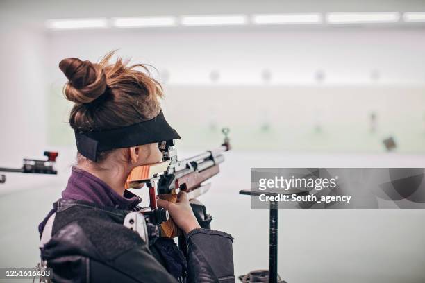 teenage girl on rifle shooting practice - shooting a weapon stock pictures, royalty-free photos & images