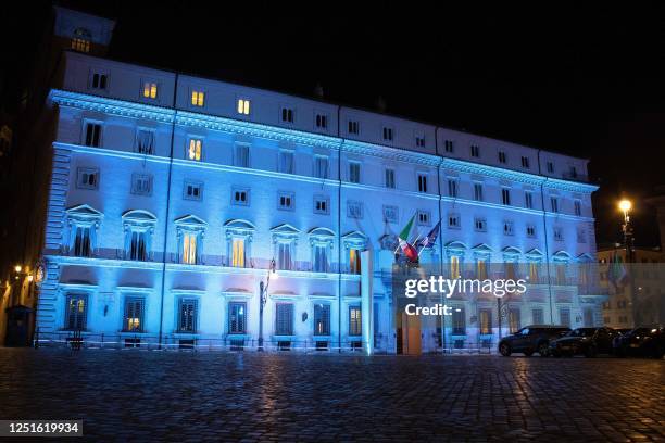 The facade of the Palazzo Chigi, the seat of the Italian government, is lit up in blue to mark the National Day of the Sea, in Rome, on April 11,...