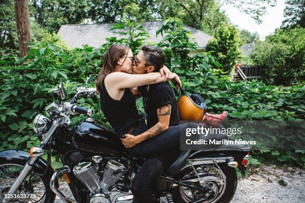 loving lesbian couple on motorcycle and kissing - lesbians kissing stock pictures, royalty-free photos & images