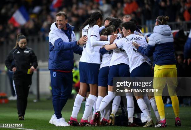 France's head coach Herve Renard celebrates with teammates after a goal during the women's international friendly football match between France and...