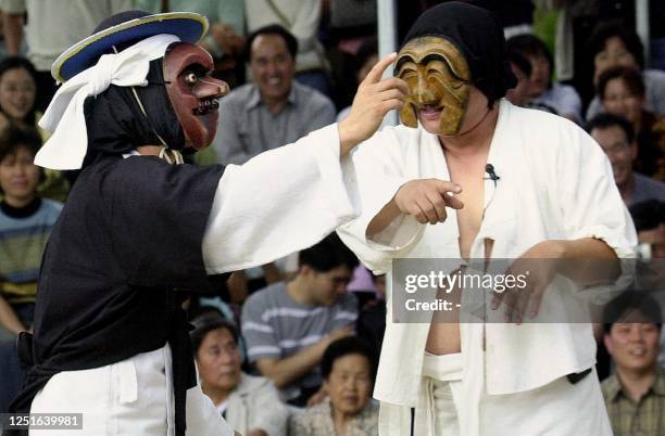 South Koreans in traditional costume dance and masks perform in the town of Ha-hye in Andong, some 280 km from Seoul, during the Andong Traditional...