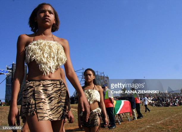 Young Khoisan girls walk near the coffin during the burial ceremony for Sarah Baartman in Hankey, Eastern Province 09 August 2002. Baartman, who was...