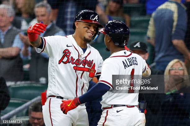 Orlando Arcia of the Atlanta Braves celebrates his two-run home run with Ozzie Albies in the fourth inning against the Cincinnati Reds at Truist Park...