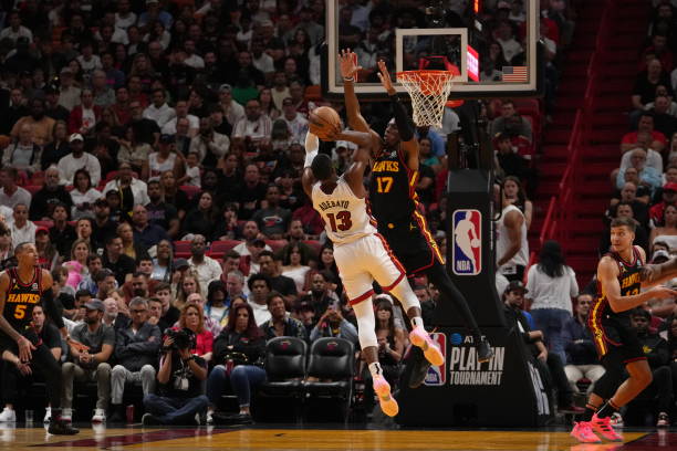 Bam Adebayo of the Miami Heat shoots the ball against defender Onyeka Okongwu of the Atlanta Hawks during the 2023 Play-In Tournament on April 11,...