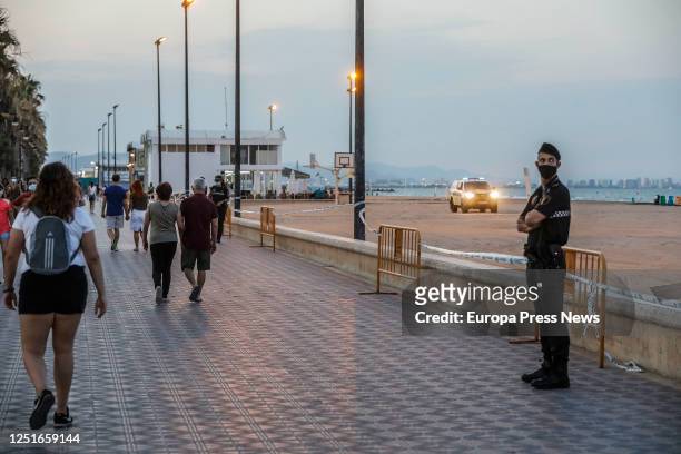 Local policeman stands guard at Malvarrosa beach during the night of San Juan, on June 23, 2020 in Valencia, Spain. Some 200 police officers in...