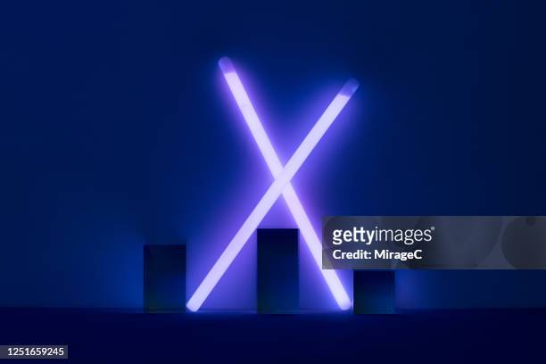 purple glow sticks crossing - letter x stock pictures, royalty-free photos & images