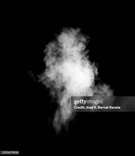 explosion by an impact of a cloud of particles of powder of white color on a black background. - vapore foto e immagini stock