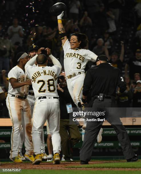 Ji Hwan Bae of the Pittsburgh Pirates celebrates at home plate after hitting a walk-off three-run home run for a 7-4 win over the Houston Astros at...