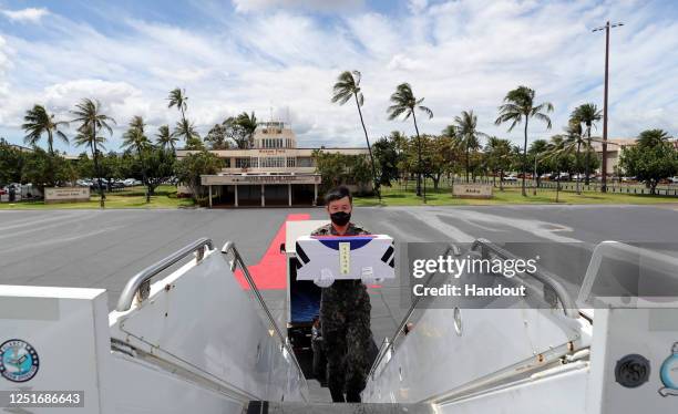 In this handout image taken on June 23, 2020 and provided by South Korean Defense Ministry, South Korean soldiers hold coffins containing the remains...