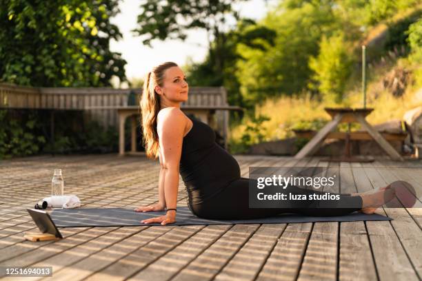 pregnant woman learning yoga online - prenatal yoga stock pictures, royalty-free photos & images