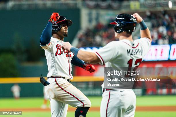 Ozzie Albies of the Atlanta Braves celebrates his 100th career home run with Sean Murphy after Albies hit a two-run home run during the fourth inning...