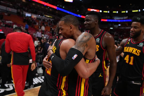 Atlanta Hawks teammates Trae Young and Dejounte Murray celebrate winning the 2023 Play-In Tournament against the Miami Heat on April 11, 2023 at...
