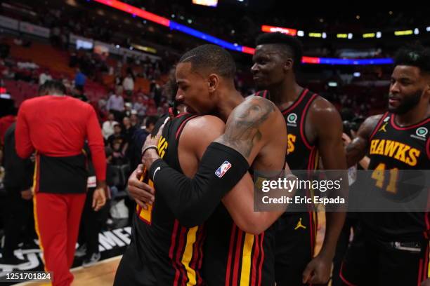 Atlanta Hawks teammates Trae Young and Dejounte Murray celebrate winning the 2023 Play-In Tournament against the Miami Heat on April 11, 2023 at...