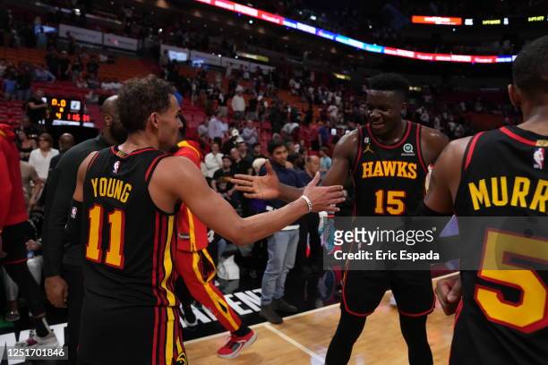 Atlanta Hawks teammates Trae Young and Clint Capela celebrate winning the 2023 Play-In Tournament against the Miami Heat on April 11, 2023 at Kaseya...