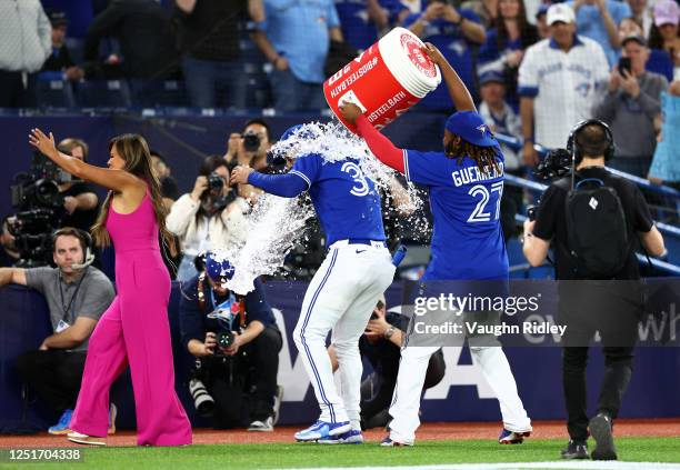 Kevin Kiermaier of the Toronto Blue Jays is doused with water by Vladimir Guerrero Jr. #27 after a win against the Detroit Tigers at Rogers Centre on...