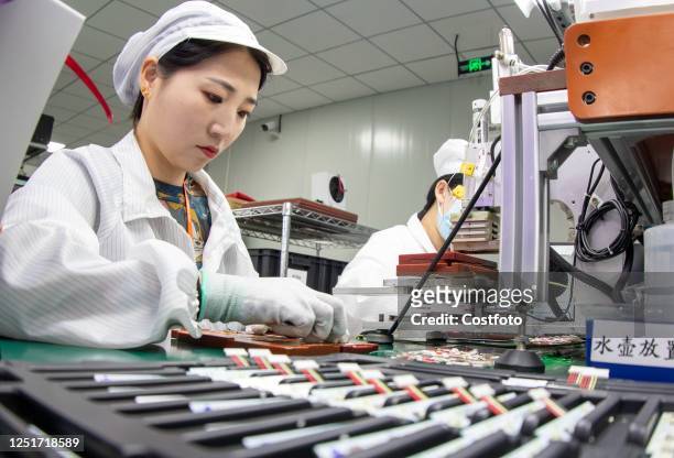 Worker makes lithium battery products for domestic and international markets at a workshop in Nantong, Jiangsu province, China, April 12, 2023.
