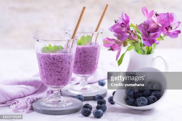 fresh blueberry smoothie in the glass - fruit smoothie stock pictures, royalty-free photos & images