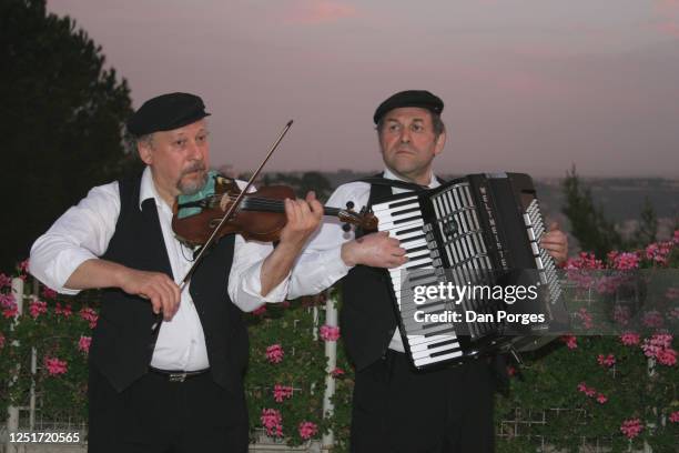 Two klezmers play at dusk in an Orthodox Jewish wedding, one plays the violin the second plays the accordion, Jerusalem, Israel, April 14, 2005. "r.