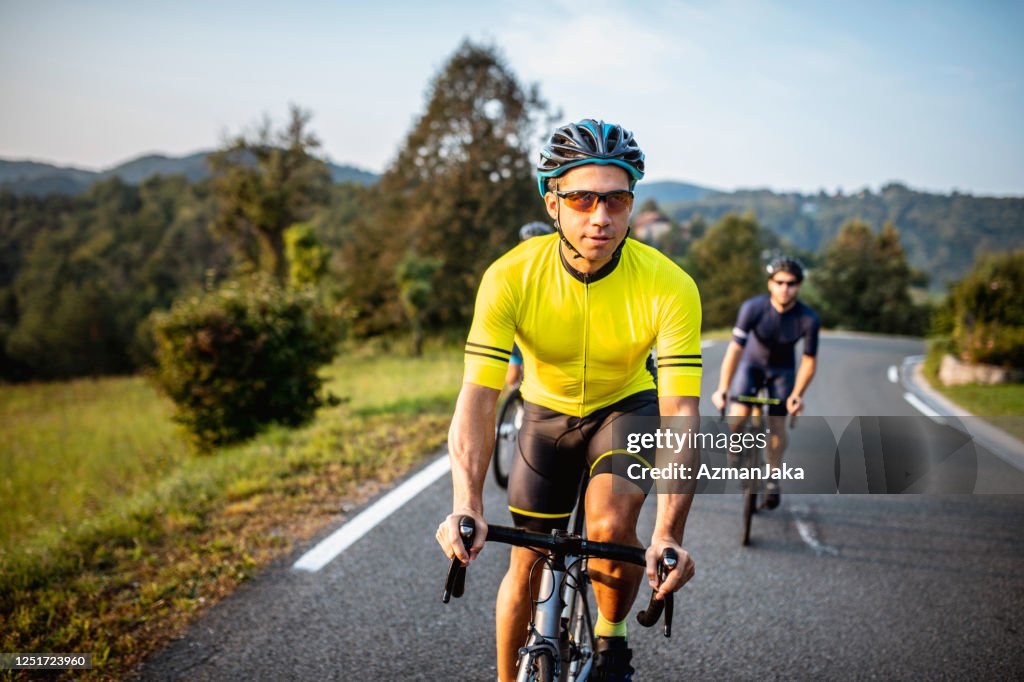 Young Men Enjoying Workout on Road Bikes in Countryside