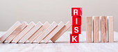 Red RISK cube blocks stop falling blocks on table. fall Business, planning, Management, Solution, Insurance and strategy Concepts