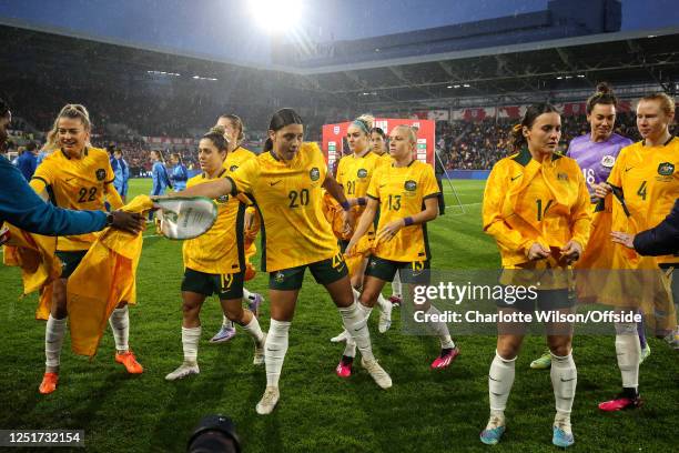 Sam Kerr hands her pennant to a member of the backroom staff as Australia Women remove their tracksuit tops ahead of the International Friendly match...