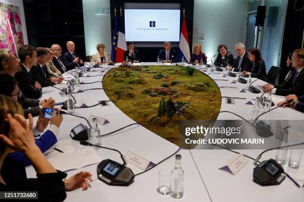 France's President Emmanuel Macron and King Willem-Alexander of the Netherlands participate in a roundtable with business leaders and majors players...