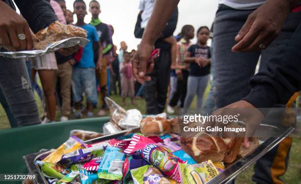 Close to a thousand children received a hot cross bun and a easter egg on Good Friday on the notorious ' Battlefield' in Lavender Hill and...