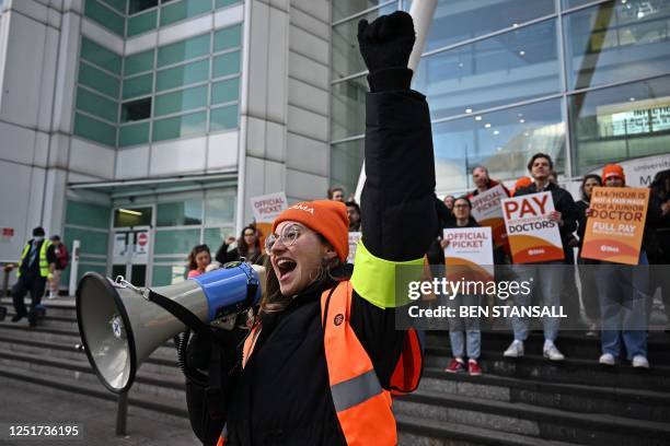 People stand on a picket line outside University College Hospital in central London on April 12 during a strike by junior doctors -- physicians who...