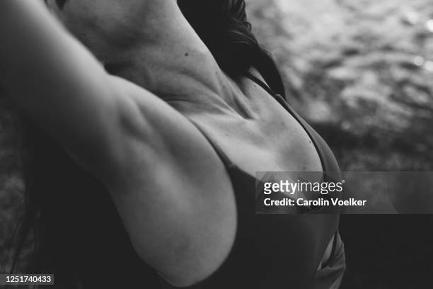 close up of the muscular chest of a woman in sports clothing - athlete torso stock pictures, royalty-free photos & images