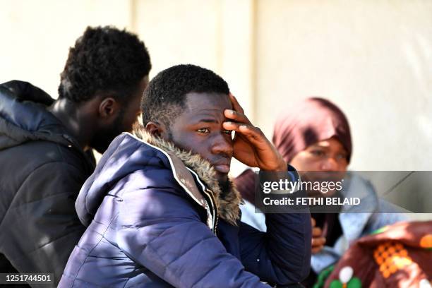 Migrants gather outside the offices of the International organisation for Migration after Tunisian police dismantled a makeshift camp for refugees...