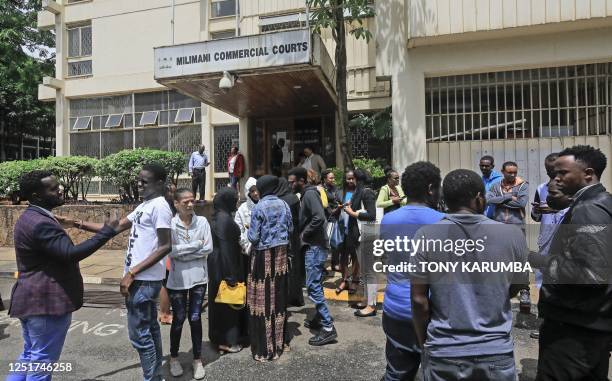 Some of the 43 former content moderators for Facebook gather to consult with their lawyer, Mercy Mutemi outside the labour court in Milimani where...