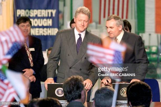 President Bill Clinton smiles as he arrives at the podium at a Gateway computer factory in Dublin 04 September, with Prime Minister of Ireland Bertie...