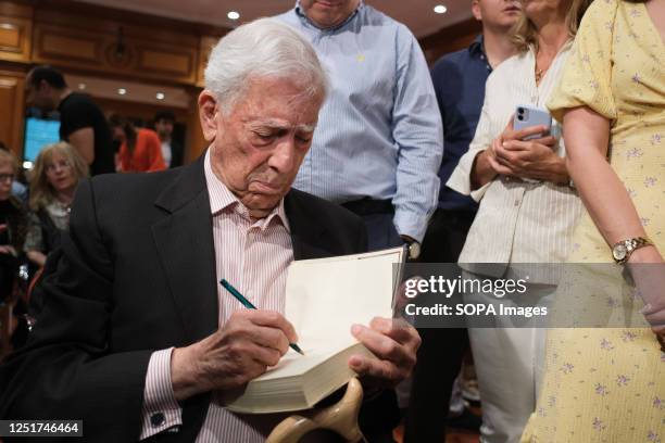 Author Mario Vargas Llosa signs one of his books for a fan during the conference 'El fuego de la imaginación' or 'The fire of imagination' at the...