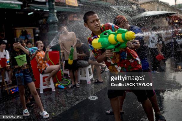 Revellers take part in a water fight on Khao San road on the eve of Thai New Year, locally known as Songkran, in Bangkok on April 12, 2023.