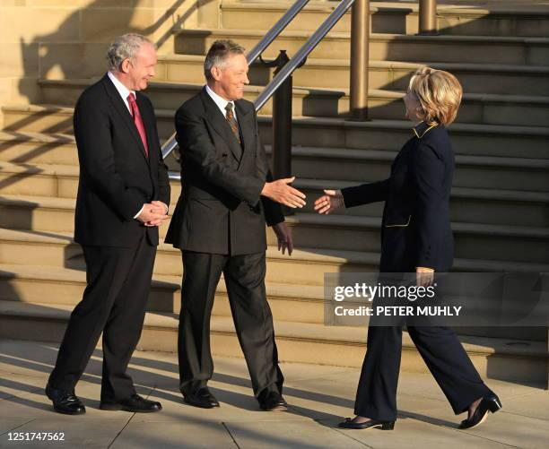 Secretary of State Hillary Rodham Clinton greets Northern Ireland's First Minister Peter Robinson and Deputy First Minister Martin McGuinness, as she...