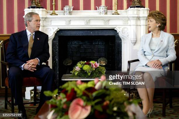 President George W. Bush confers with President of Ireland Mary McAleese, in the Drawing Room of Dromoland Castle 25 June 2004 in...