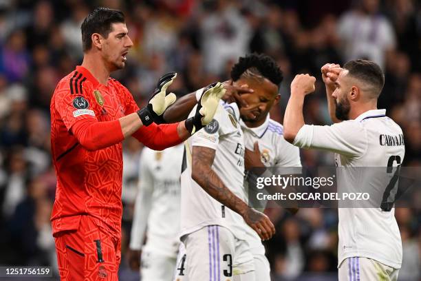 Real Madrid's Belgian goalkeeper Thibaut Courtois celebrates with Real Madrid's Spanish defender Dani Carvajal during the UEFA Champions League...