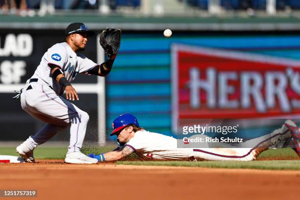 Bryson Stott of the Philadelphia Phillies steals second base as second baseman Luis Arraez of the Miami Marlins waits for the throw during the first...