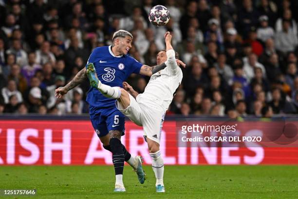 Chelsea's Argentinian midfielder Enzo Fernandez vies with Real Madrid's Croatian midfielder Luka Modric during the UEFA Champions League quarter...