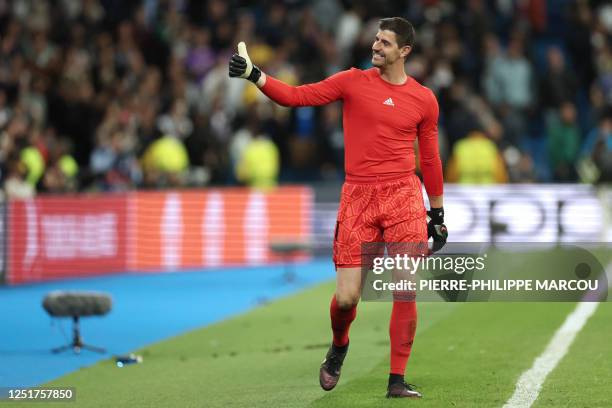 Real Madrid's Belgian goalkeeper Thibaut Courtois gives a thumb up as he celebrates their victory at the end of the UEFA Champions League quarter...