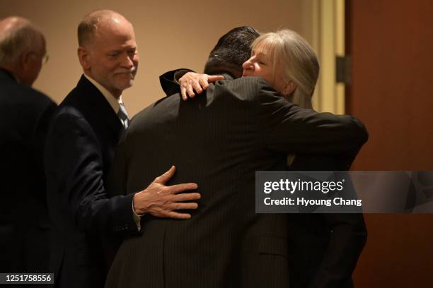 Desiree Davis, right, and her husband Michael, left, parents of Claire Davis who was shot and killed Arapahoe High School, comfort John Castillo,...