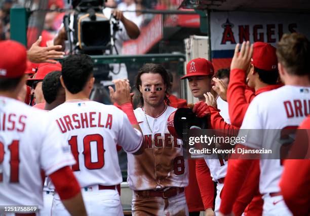 Brett Phillips of the Los Angeles Angels celebrates in the dugout after stealing third base and scoring on a throwing error by the catcher Keibert...