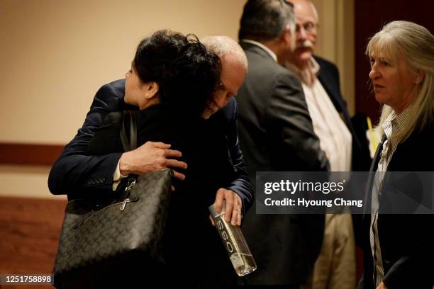 Michael Davis, father of Claire Davis who was shot and killed Arapahoe High School, facing, comforts Maria Castillo, mother of Kendrick Castillo, by...