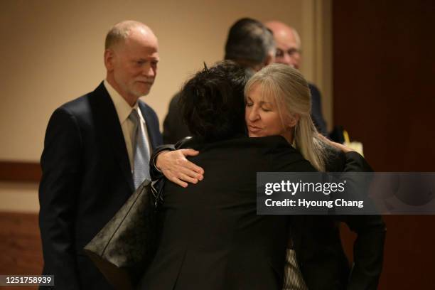 Desiree Davis, right, and her husband Michael, left, parents of Claire Davis who was shot and killed Arapahoe High School, comfort Maria Castillo,...