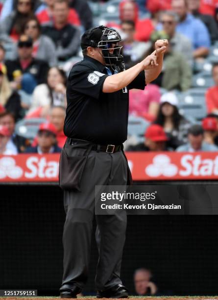 Home plate umpire Doug Eddings calls for pitch clock violation against starting pitcher Griffin Canning of the Los Angeles Angels against the...