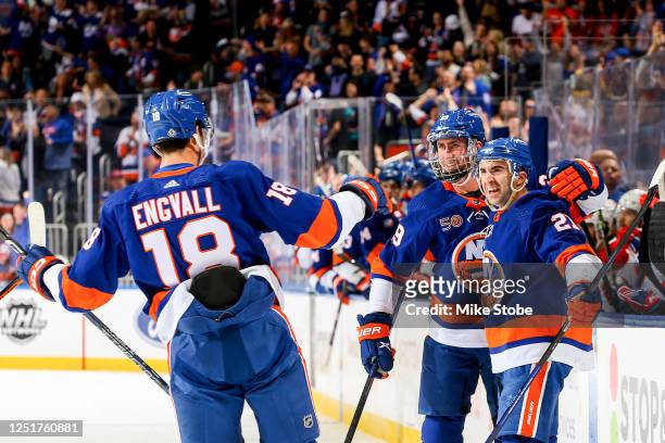 Brock Nelson of the New York Islanders is congratulated by his teammates Pierre Engvall and Kyle Palmieri after scoring a goal against the Montreal...